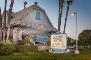 a hotel and suites sign in front of a house at Azure Hotel&Suites Ontario Trademark Collection by Wyndham in Ontario