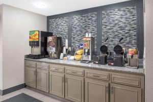 a breakfast counter in a hotel room with a coffee machine at Days Inn by Wyndham Carthage in Carthage