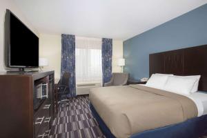 A television and/or entertainment centre at AmericInn by Wyndham Mount Pleasant