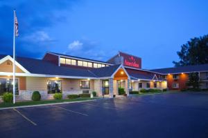 a hotel with a parking lot in front of it at AmericInn by Wyndham Fergus Falls Conference Center in Fergus Falls