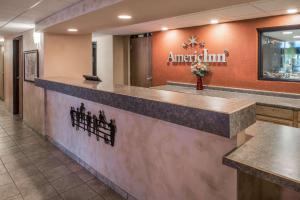 a lobby of a american inn with a reception counter at AmericInn by Wyndham Belle Fourche in Belle Fourche +41 photos
