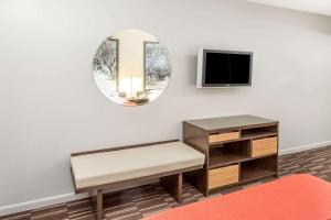 a living room with a mirror and a tv at Super 8 by Wyndham Adel GA I-75 in Adel