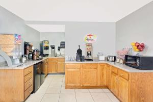 a large kitchen with wooden cabinets and appliances at Super 8 by Wyndham Athens in Athens +8 photos