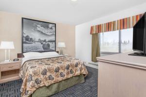 Voodi või voodid majutusasutuse Super 8 by Wyndham Stettler toas