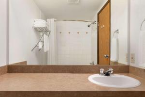 a bathroom with a sink and a shower at Super 8 by Wyndham Yellowknife in Yellowknife +20 photos
