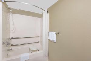 a bathroom with a shower with a towel at Super 8 by Wyndham Macomb in Macomb +55 photos