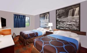 a hotel room with two beds and a tv at Super 8 by Wyndham Fayetteville in Fayetteville
