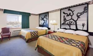 a hotel room with two beds and two lamps at Super 8 by Wyndham Yucca Val/Joshua Tree Nat Pk Area in Yucca Valley