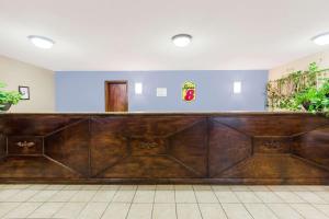 a large wooden bar in a room at Super 8 by Wyndham Jonesboro in Jonesboro