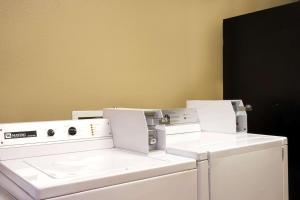 a laundry room with two washer and dryer at Super 8 by Wyndham Chandler Phoenix in Chandler