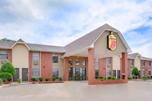 a hotel with a donut sign on the front of it at Super 8 by Wyndham Morrilton in Morrilton