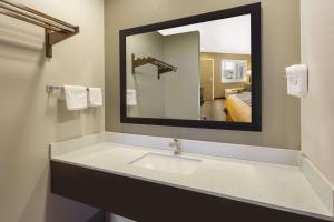 a bathroom with a sink and a mirror at Super 8 by Wyndham Fortuna in Fortuna +37 photos