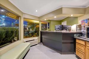 a restaurant with a counter and a food at Super 8 by Wyndham Santa Cruz Beach Boardwalk in Santa Cruz