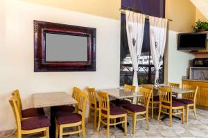 a restaurant with two tables and chairs and a window at Mission Inn San Luis Obispo in San Luis Obispo