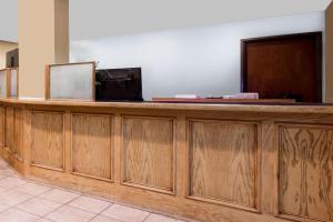 a wooden reception desk in a lobby with at Super 8 by Wyndham Dillon/Breckenridge Area in Dillon