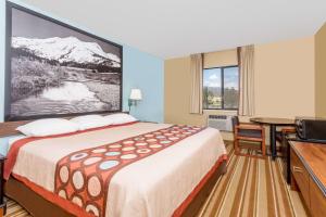 a hotel room with a bed and a television at Super 8 by Wyndham Dillon/Breckenridge Area in Dillon