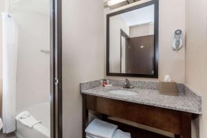 a bathroom with a sink and a mirror at Super 8 by Wyndham Longmont/Twin Peaks in Longmont