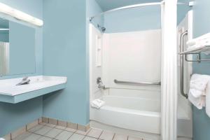 a bathroom with a tub and a toilet and a sink at Super 8 by Wyndham Dillon/Breckenridge Area in Dillon
