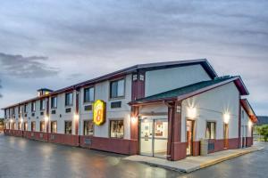 a building with a sign on the side of it at Super 8 by Wyndham Crystal Lake in Crystal Lake