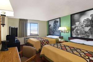 a hotel room with two beds and a television at Super 8 by Wyndham Alamogordo in Alamogordo