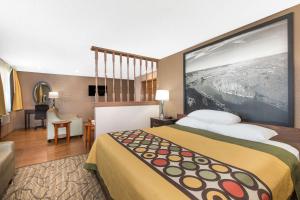 a hotel room with a bed with a large wall at Super 8 by Wyndham Nampa in Nampa
