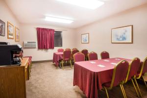 a conference room with tables and chairs and a tv at Super 8 by Wyndham Abilene KS in Abilene