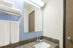 a bathroom with a sink and a mirror at Super 8 by Wyndham New Castle in New Castle