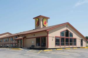 a building with a clock tower in a parking lot at Super 8 by Wyndham Chadron NE in Chadron