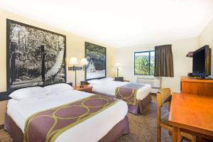 a hotel room with two beds and a desk at Super 8 by Wyndham Ripley in Ripley