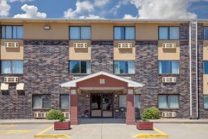 an exterior view of a building with the front entrance at Super 8 by Wyndham Evansville East in Evansville