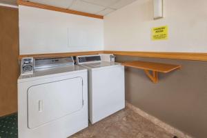 a laundry room with a washer and dryer in it at Super 8 by Wyndham Ionia MI in Ionia