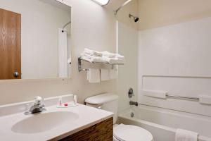 a white bathroom with a sink and a toilet at Hillside Inn & Suite in Martinsburg +11 photos