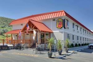 a fast food restaurant with tables and chairs in a parking lot at Super 8 by Wyndham Cody in Cody