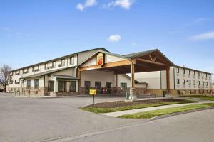 a large building with a sign in front of it at Super 8 by Wyndham Bozeman in Bozeman