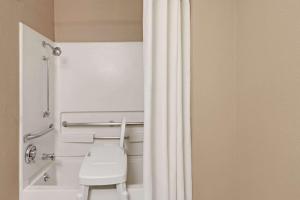 a bathroom with a toilet and a shower curtain at Super 8 by Wyndham Nashville/ Dntn/ Opryland Area in Nashville