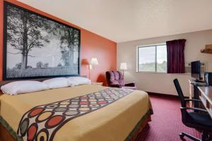 a hotel room with a large bed and a window at Hillside Inn & Suite in Martinsburg