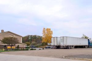 a semi truck parked in front of a house at Super 8 by Wyndham Youngstown/Austintown in Youngstown
