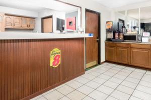 a fast food restaurant with a counter and a kitchen at Super 8 by Wyndham Kent/Akron Area in Kent