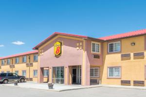 a fast food building with a p motel sign at Super 8 by Wyndham Moriarty in Moriarty