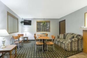 a living room with a couch and a table at Super 8 by Wyndham Twinsburg/Cleveland Area in Twinsburg