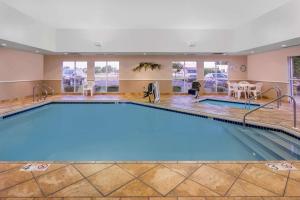 a large swimming pool in a hotel room at Super 8 by Wyndham Madison South in Madison