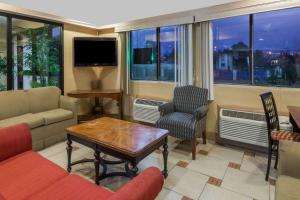 a living room with a couch and a table and chairs at Super 8 by Wyndham Hartford in Hartford