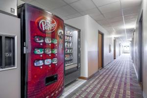 a soda vending machine in a hallway of a building at Super 8 by Wyndham Fond Du Lac in Fond du Lac