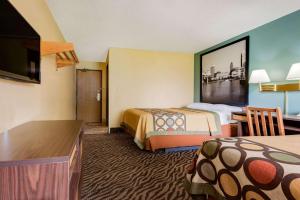 a hotel room with two beds and a flat screen tv at Super 8 by Wyndham Mentor/Cleveland Area in Mentor