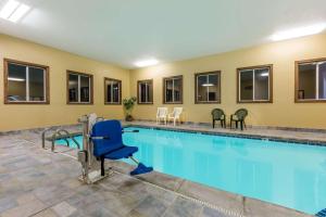 a pool in a hotel room with a large swimming pool at Super 8 by Wyndham Grinnell IA in Grinnell