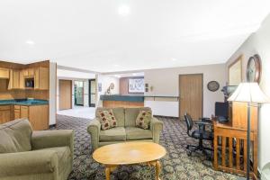 a living room with a couch and a table at Super 8 by Wyndham Dodgeville in Dodgeville