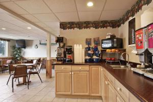 a kitchen with a counter top and a dining room at Hotel Iron Mountain Inn & Suites - Stay Express Collection in Iron Mountain