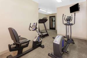 a gym with two exercise bikes and a television at Super 8 by Wyndham Imlay City in Imlay City