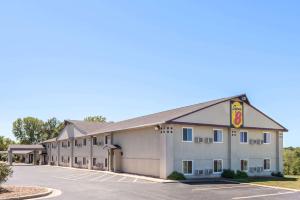 une vue de devant d'un hôtel avec un parking dans l'établissement Super 8 by Wyndham Higginsville, à Higginsville