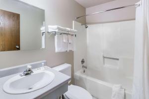 a white bathroom with a sink and a toilet at Super 8 by Wyndham Madison in Madison +8 photos